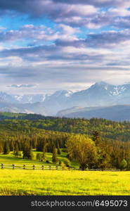 Inspiring evening light in spring. Sunset in Tatra Mountains, Poland. Mountain ridge over cloudy sky. Evening light in spring. Sunset in Tatra Mountains, Poland