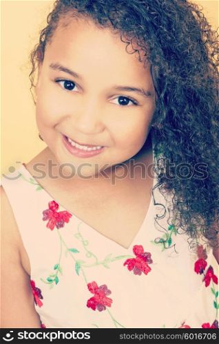 Instagram style filter photograph of a beautiful young mixed race African American girl smiling and looking happy