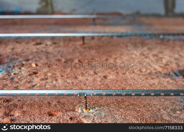 Installation of a guide for the concrete screed. Repair and rough finish in the apartment.