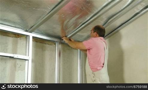 Installation of gypsum plasterboard ceilings, Medium shot