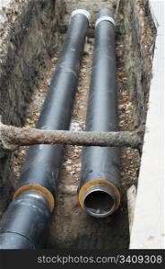 Installing pipes for hot water and steam heating. City heat pipeline