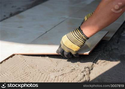 Installing tiles floor in construction work