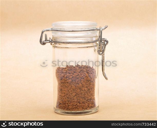 Instant Coffee in closed jar on brown background