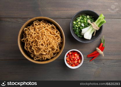 Instant noodles in white black on wood background