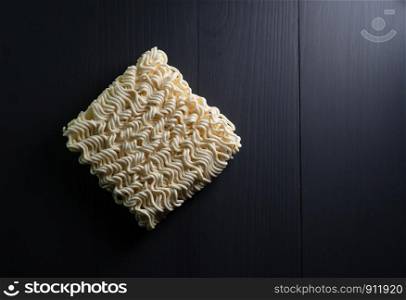 instant noodles on dark background which main ingredient from wheat, top view close up with copy space