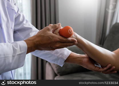 instructor assisting senior doing exercise working out in clinic strengthening muscles and developing joints