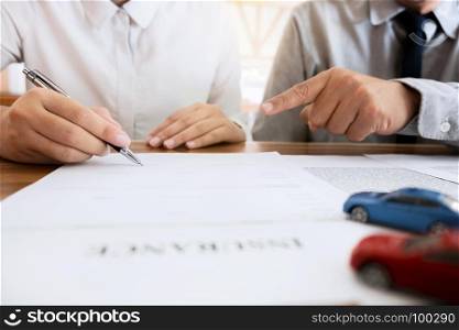 Insurance agent explain consulting with customer to signing the policy form.