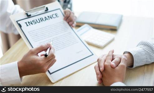 Insurance concept the auto dealer emphasizing on the agreement of the contract for his client.