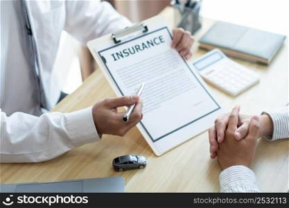 Insurance concept the auto dealer emphasizing on the agreement of the contract for his client.