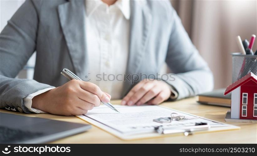 Insurance concept the realtor dealing with a customer and signing on a contract of property.