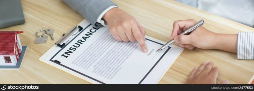 Insurance concept the selling broker reading the contract of purchasing house to his customer.