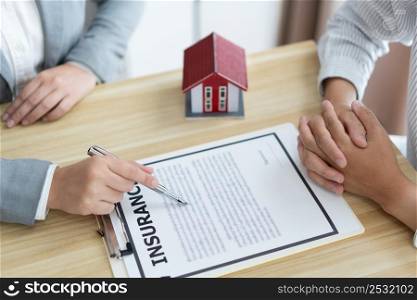 Insurance concept the selling broker reading the contract of purchasing house to his customer.