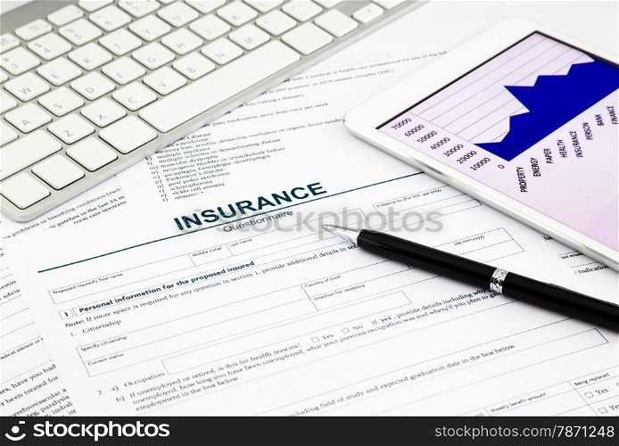 insurance questionnaire and tablet on office table