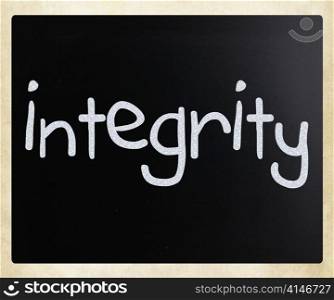 ""Integrity" handwritten with white chalk on a blackboard"