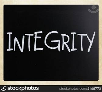 ""Integrity" handwritten with white chalk on a blackboard"