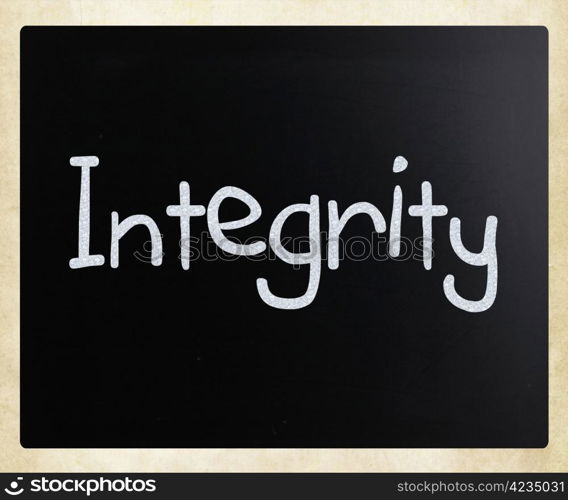 ""Integrity" handwritten with white chalk on a blackboard."