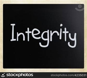 ""Integrity" handwritten with white chalk on a blackboard."