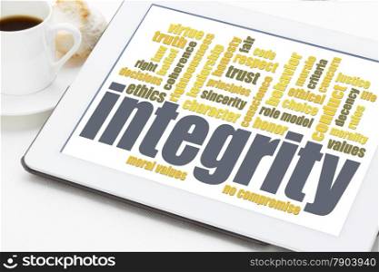integrity word cloud on digital tablet with a cup of coffee
