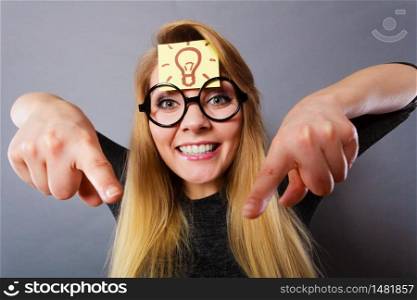 Intellectual expressions, being focused concept. Woman wearing weird nerd eyeglasses having light bulb mark on forehead thinking about something, having great idea or solution. Woman having light bulb mark on forehead thinking