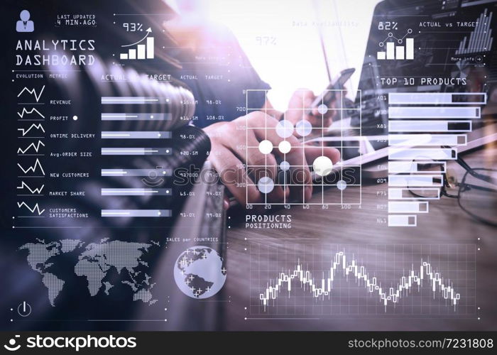 Intelligence (BI) and business analytics (BA) with key performance indicators (KPI) dashboard concept.designer hand working with digital tablet and laptop computer and book stack and eye glass on wooden desk.