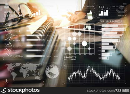 Intelligence (BI) and business analytics (BA) with key performance indicators (KPI) dashboard concept.designer hand working with digital tablet and laptop computer and book stack and eye glass on wooden desk.