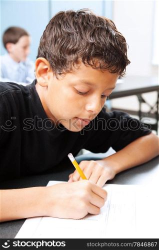 Intelligent school boy taking a standardized test in school.
