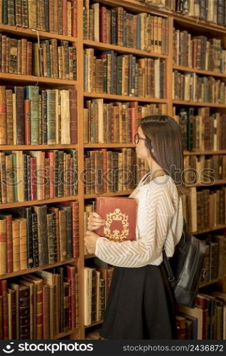 intelligent woman with book library