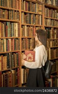 intelligent woman with book library