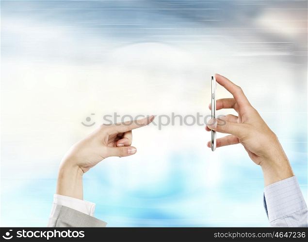 Interaction concept. Two business people using one mobile phone at the same time