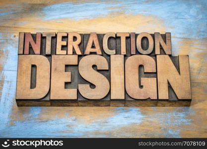 interaction design - designing interactive digital products, environments, systems, and services - word abstract in vintage letterpress wood type against grunge wooden background