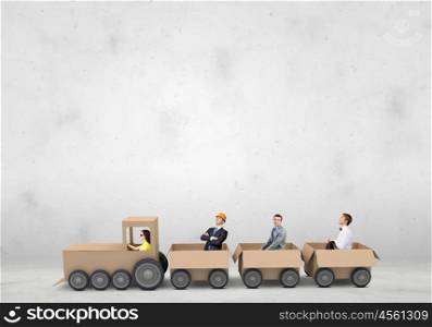 Interaction in business. Business people riding carton train. Teamwork concept