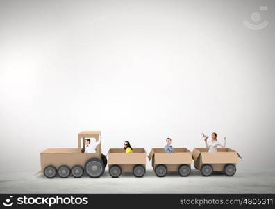 Interaction in business. Business people riding carton train. Teamwork concept