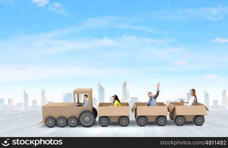 Interaction in business. Business people riding carton train. Teamwork concept