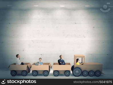 Interaction in business. Business people riding carton train. Teamwork concept