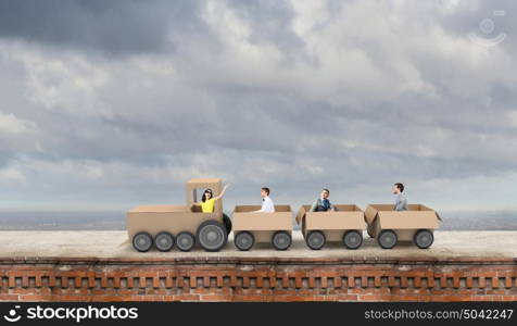 Interaction in business. Business people riding carton train. Teamwork concept