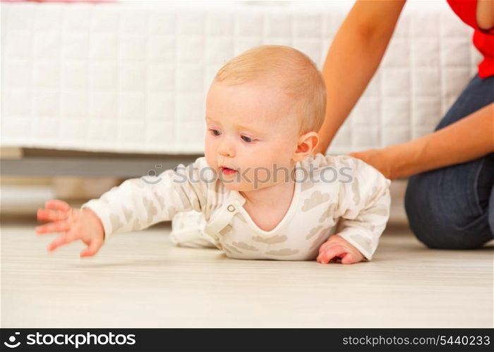 Interested baby stretching hand for something