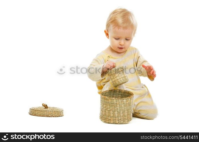 Interested kid playing with basket isolated on white