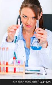 Interested woman researcher working with test tubes in medical laboratory&#xA;