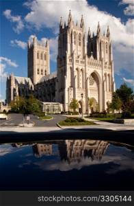 Interesting perspective of Washington National Cathedral reflected in roof of car parked opposite