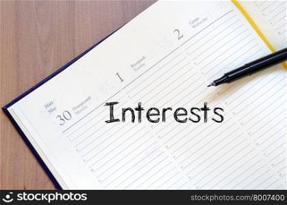 Interests text concept write on notebook with pen