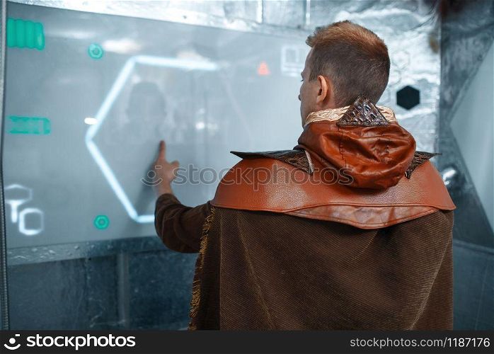 Intergalactic space scientist enter data on the teleport board, spacecraft with foil walls. Fantasy spaceship for interstellar travel, future science and technology. Space scientist enter data on the teleport board