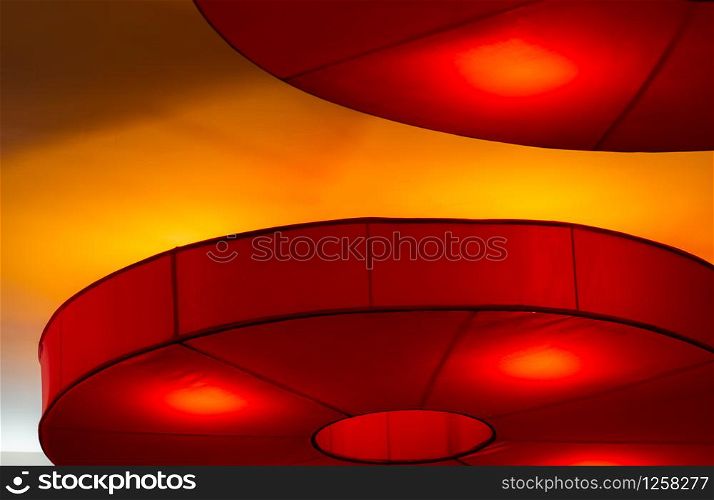 Interior ceiling red lights on dark background at night. Interior lighting concept. Red lights on ceiling wall. Interior architecture.