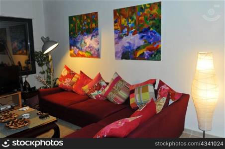 interior cosy with red sofa and pictures on the wall