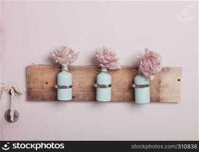Interior decoration with bottles on pink wall.Pink flowers.Great for wedding interior