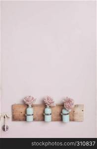 Interior decoration with bottles on pink wall.Pink flowers.Great for wedding interior