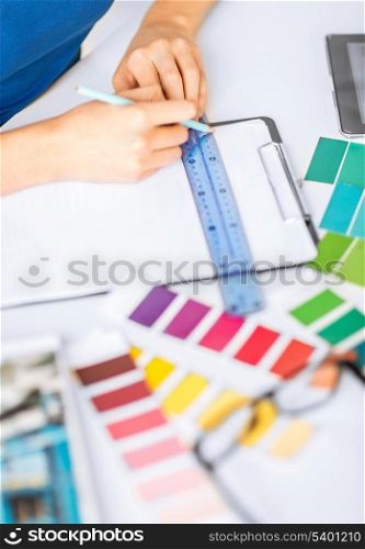 interior design and renovation concept - woman working with color samples for selection