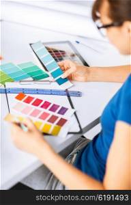 interior design and renovation concept - woman working with color samples for selection. woman working with color samples for selection