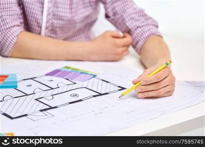 interior design, architecture and people concept - close up of architect&rsquo;s hands working with blueprint, pencil and color palettes. architect with blueprint and color palettes