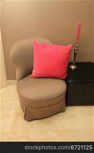 Interior design: classic chair, hocker and silver and pink accessoiries