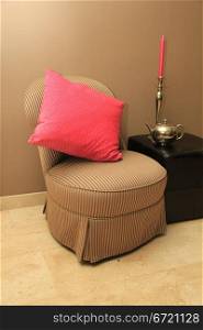 Interior design: classic chair, hocker and silver and pink accessoiries